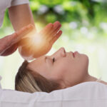 Reiki practitioner transferring healing energy through hands-on techniques